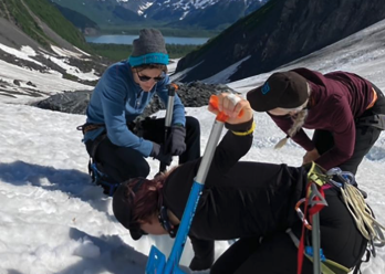 Photo of Shaun, Summer, and Dr. Lyons shoveling snow in the mountains